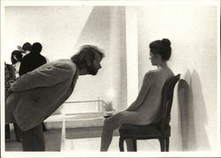 Photograph of Man Leaning Into a Nude Woman Seated Postcard