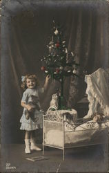 Little Girl Standing by Christmas Tree and Crib Postcard