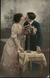 Couple Kissing next to Flowers Couples Postcard Postcard