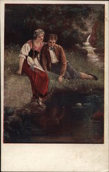 Young Man and Woman Seated Near Water's Edge in Grass Art Postcard Postcard