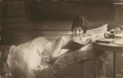 Woman Laying on Bed Reading Book Postcard