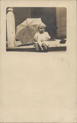 Baby Holding Umbrella on Porch Postcard