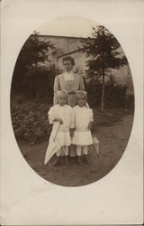 A Woman With Two Small Girls Postcard