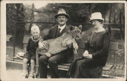 Family Holding Lion at Zoo Postcard