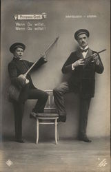 Two Men Posed With Chair, One Holding a Broom Postcard