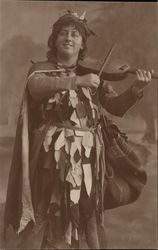 Man in Tattered Costume Playing Stringed Instrument with Bow Postcard