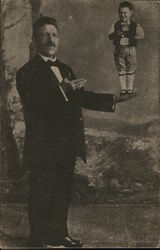 Man with Arm Extended, Holding Tiny Man Postcard