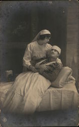 Uniformed Nurse Cradling Injured Soldier Postcard