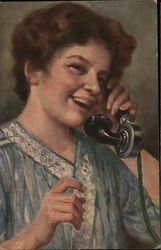 Woman speaking on an early telephone Postcard