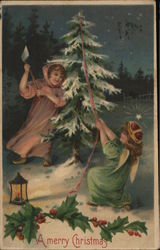 A Merry Christmas - A Pair of angels chopping down a tree Postcard Postcard