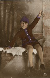 Boy sitting on a snowy ledge Postcard