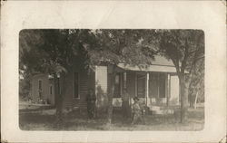 Family Posing In Front of Home Postcard