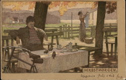 Man relaxes after picnic as woman tends to clothes Postcard