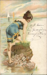 Woman leans on rock in ocean Postcard