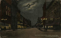 Main Street from Academy Street looking West, at Night Postcard