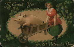 A large pig in a wheelbarrow bushed by a woman. Postcard