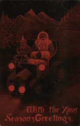 With the Xmas Season's Greetings-Santa and elf in car Postcard