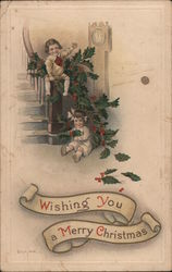 Two Children on Stairs Decorated With Holly Postcard