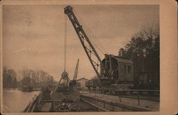 "Ardelt" Locomotive-steam-crane with grab shifting coal from Barge into Truck. Postcard