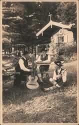 Trio of musicians seated outside Postcard Postcard Postcard