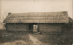 Log cabin with thatched roof Postcard