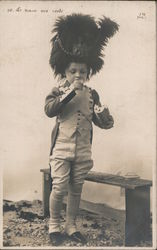 A Little Boy in a Uniform and a Large Hat Eating French Bread Postcard