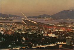 View of a plane making a night landing at Kaitak Hong Kong China Postcard Postcard Postcard