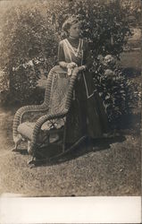 Woman Posing by Wicker Rocker Postcard