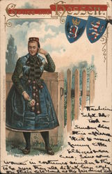 Woman in traditional dress with coats of arms - Greetings from Hessen Postcard