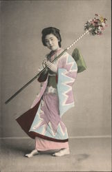 A Geisha lady holding a stick with flowers Japan Postcard Postcard Postcard