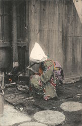 A lady lighting a fire Japan Postcard Postcard Postcard