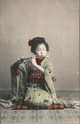 A Geisha lady with a flute Japan Postcard Postcard Postcard