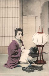 A lady writing on a sheet of paper Postcard