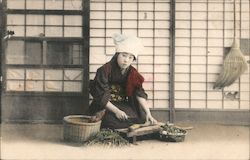 A lady chopping vegetables Postcard