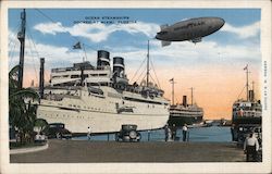 Ocean Steamships Docked and Good Year Blimp Postcard