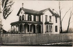 White wooden house with picket fence Postcard