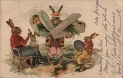 A family of anthropomorphic rabbits with two boxes of chicks Postcard