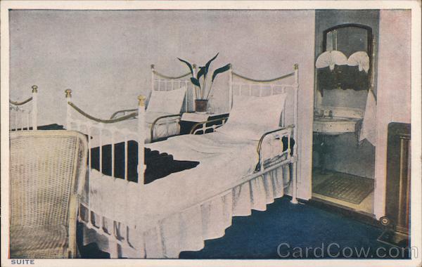 two-beds-with-white-linens-adjoining-a-bathroom-cruise-ships-postcard