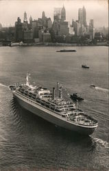 A boat coming in to harbor with the New York skyline in the background. Postcard