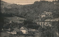 Locomotive traveling over a French mountain town Postcard