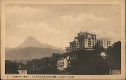 View of a hotel with a mountaintop in the background Evian-les-Bains, France Postcard Postcard Postcard