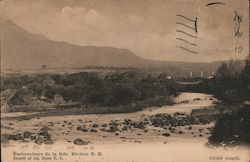 Photograph of a river with a mountain in the background Postcard