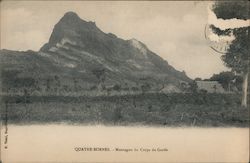 Photograph of a mountain with a stone wall in the foreground Postcard