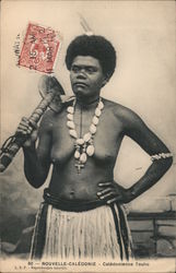 A Pacific Islander woman wearing a shell necklace and grass skirt holding a cudgel Touho, New Caledonia South Pacific Postcard P Postcard