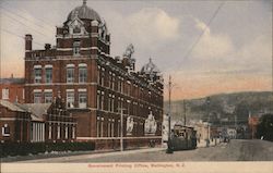 Brick government building on a street with a mountain in the background Postcard