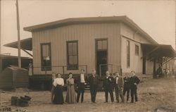 Nine People Standing In Front of a Building Postcard