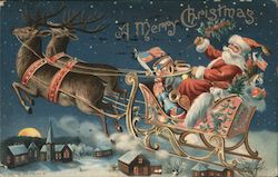 A Merry Christmas - Santa Driving his Sleigh over a Town with 2 Reindeer Pulling it Santa Claus Postcard Postcard Postcard