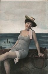 A woman relaxing in a bathing suit and hat Postcard