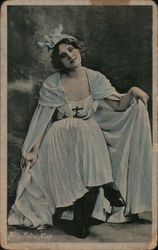 A young woman sitting down with her head tilted to the side with a smile on her face. Women Postcard Postcard Postcard