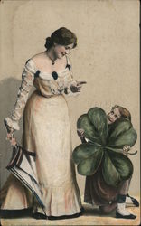 A child holds a giant four leaf clover while a woman with a closed umbrella smiles at her Postcard